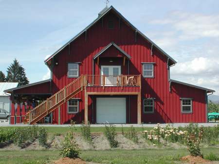 A red barn with stairs leading to the top.