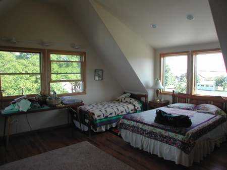 A bedroom with two beds and a window.