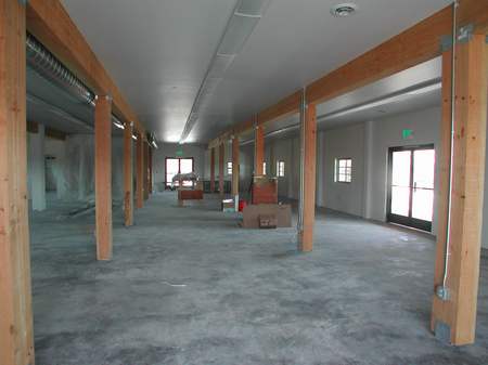 A large room with many wooden pillars and floors.
